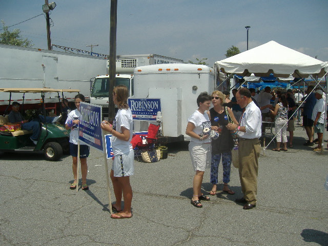 Democrat Congressional candidate Chris Robinson (far right, in white shirt and tie) talks with some of his small legion of helpers at the Tawes Crab and Clam Bake.